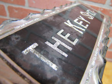 Load image into Gallery viewer, THE KEY SHOP Antique Reverse on Chip Scalloped Glass Advertising Sign ROG
