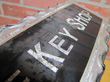 Load image into Gallery viewer, THE KEY SHOP Antique Reverse on Chip Scalloped Glass Advertising Sign ROG