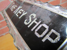 Load image into Gallery viewer, THE KEY SHOP Antique Reverse on Chip Scalloped Glass Advertising Sign ROG