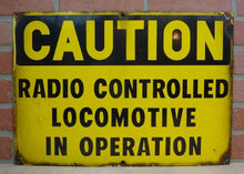 Load image into Gallery viewer, CAUTION RADIO CONTROLLED LOCOMOTIVE IN OPERATION Old Porcelain Sign RR Train
