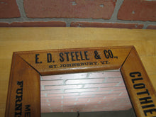 Load image into Gallery viewer, E D STEELE & Co ST JOHNSBURY VT CLOTHIERS HATTERS Antique Wooden Frame Advertising Mirror Sign Impressed Lettering