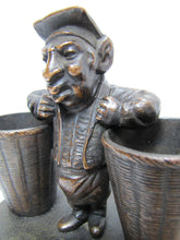 Load image into Gallery viewer, Man with Baskets Old Figural Match Holders Double Matchstick Striker Art
